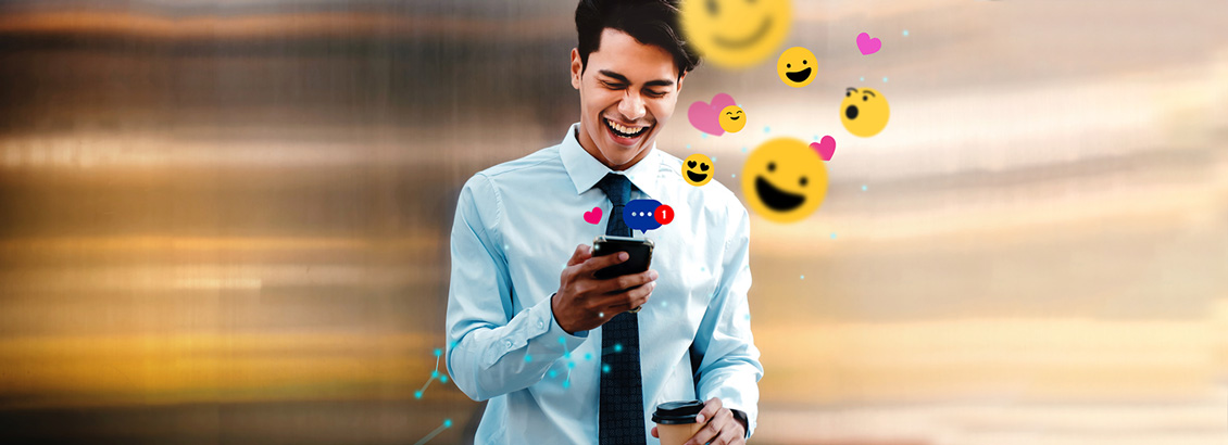 Chico Mirando Twitter en su Teléfono Mientras Reacciona con Nuevos Emojis