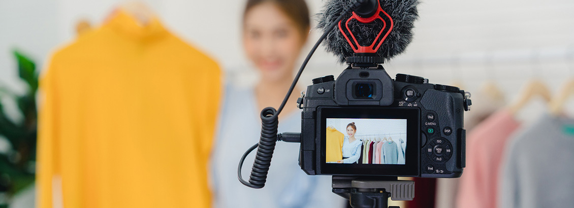 Cámara Grabando a Mujer que Muestra Prendas de Ropa a sus Seguidores
